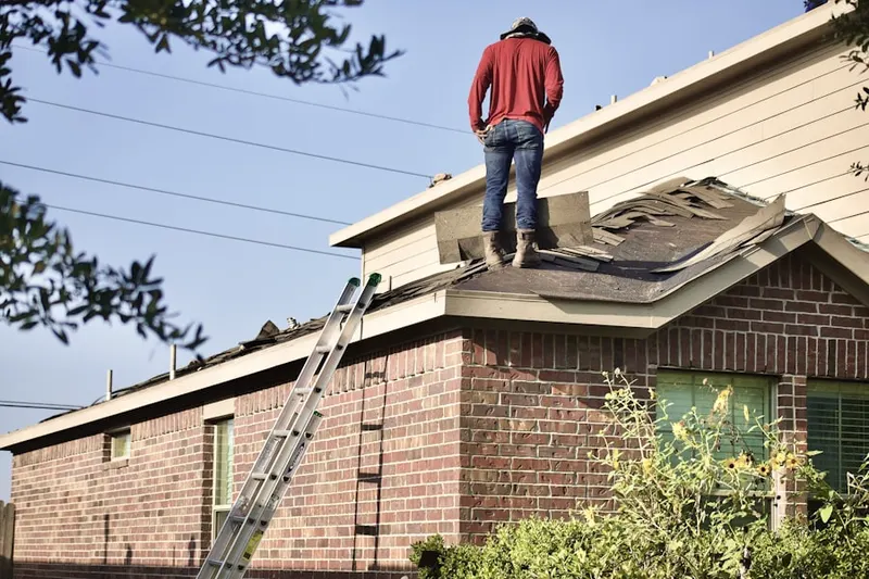 Professional roofer working on a residential roof in Montserrat